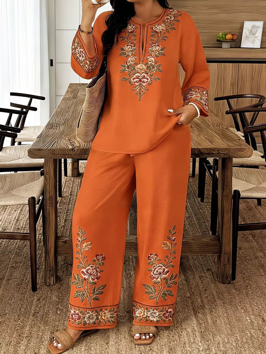 Orange embroidered peasant blouse and wide-leg pants set with floral details.