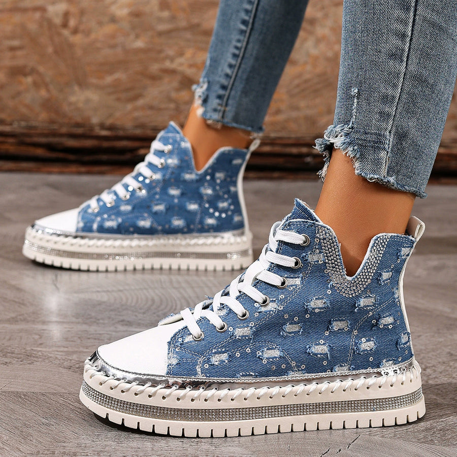 Blue denim high-top platform sneakers with white laces and rhinestone-embellished platform.
