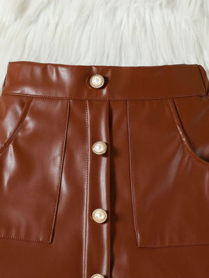 Brown faux leather baby skirt with decorative pearl buttons and pockets.