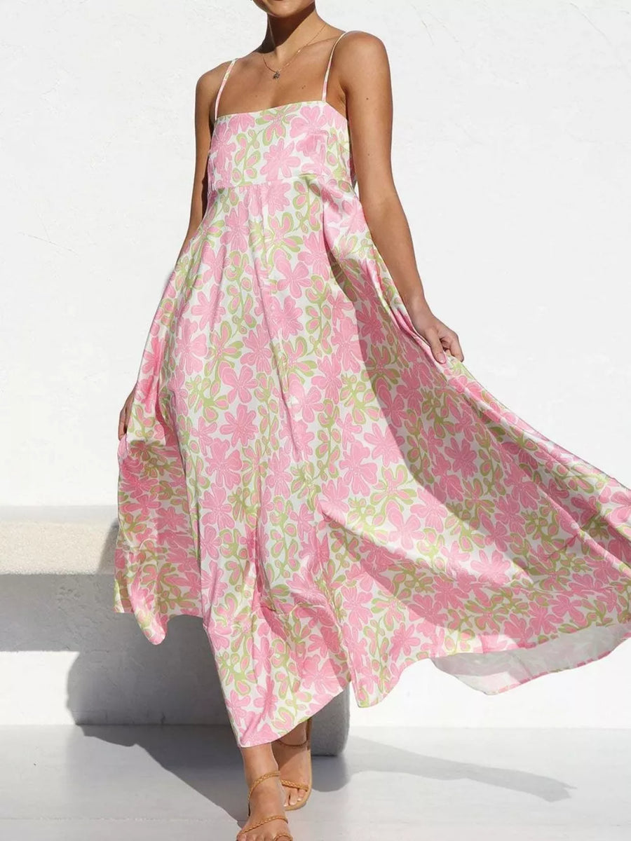 Maxi dress with spaghetti straps and a pink and green floral print.
