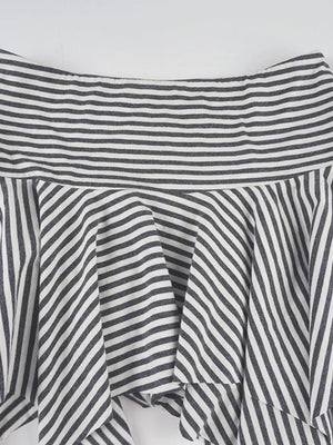 Asymmetrical hem mini skirt with black and white stripes and a ruffled detail.