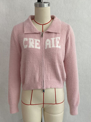 White cardigan with zip-front and letter graphic
