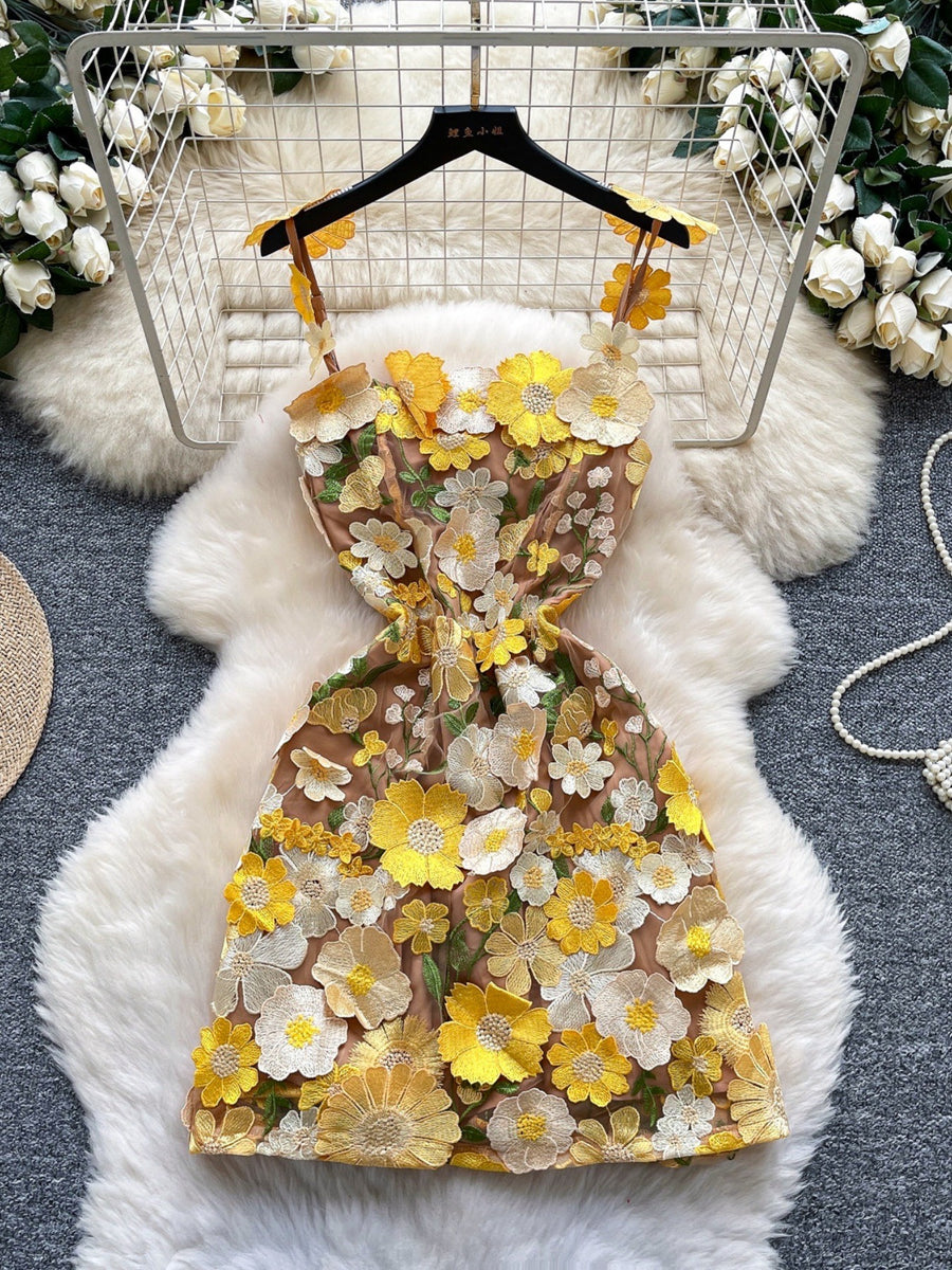 Embroidered floral mini dress with yellow and white flowers on a tan mesh.