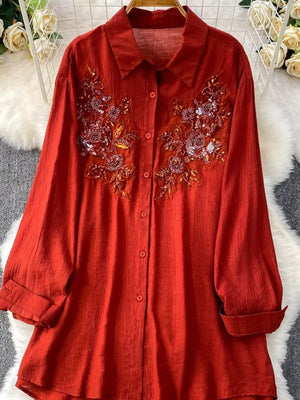 Red embroidered floral collared shirt with sequin details and button front.