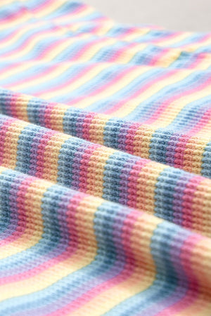 Rainbow stripe culotte jumpsuit in sherbet cotton with a waffle knit texture.