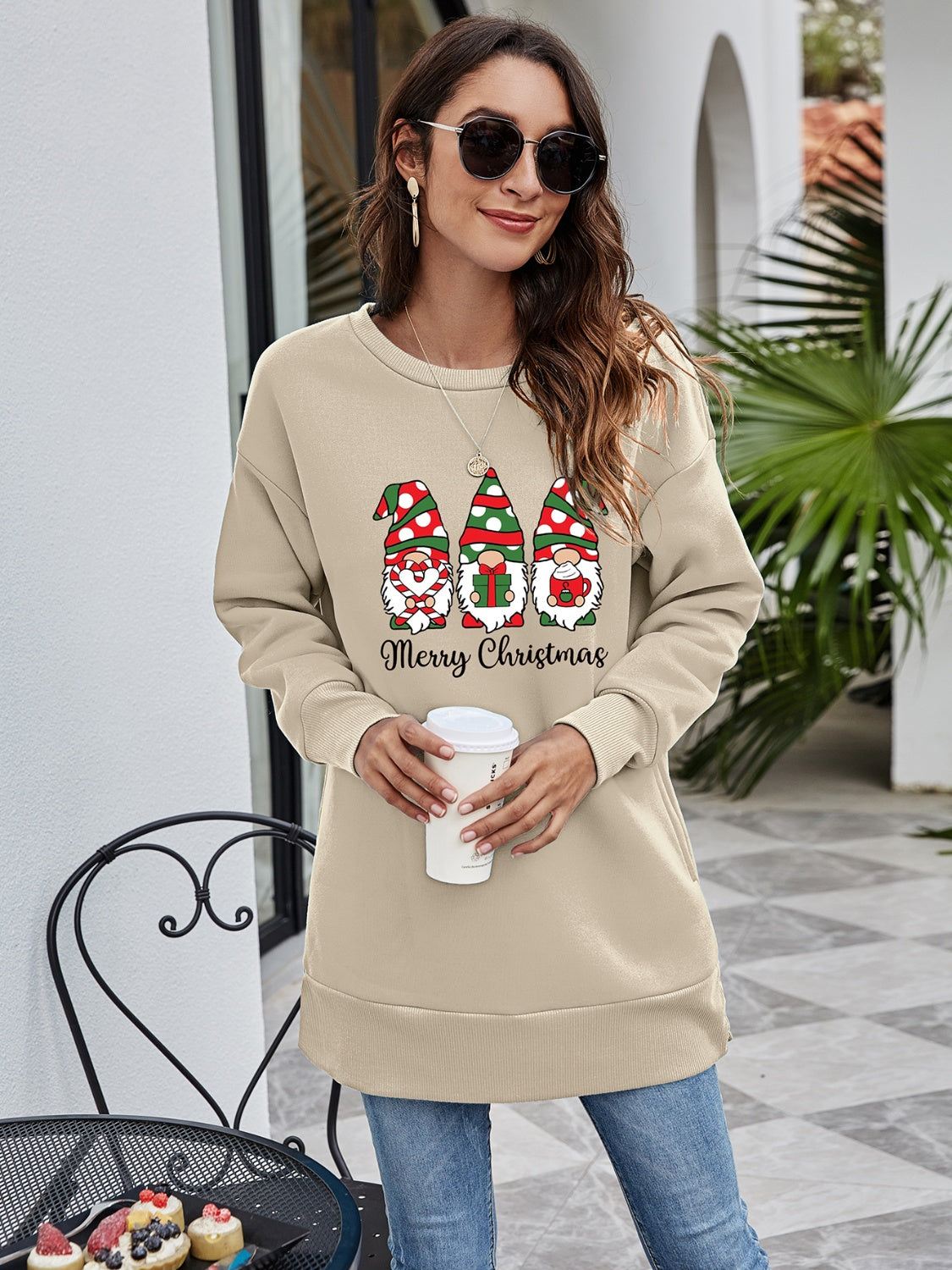 Beige tunic sweatshirt with Christmas gnomes and Merry Christmas graphic.