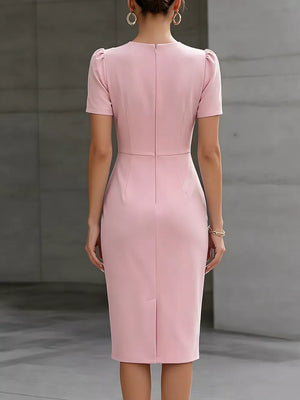 Pink midi dress with short puff sleeves, ruched waist detail, and back zipper.