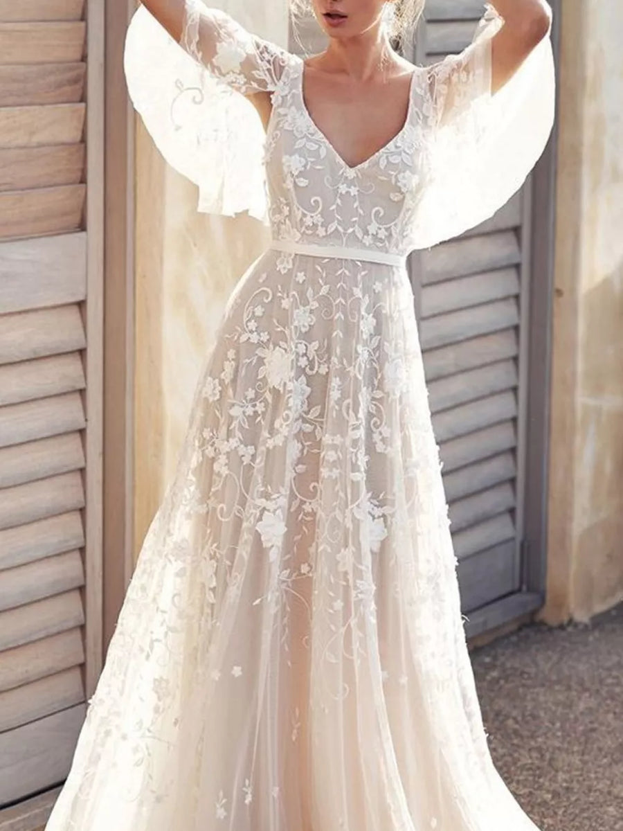 White lace flutter sleeve v-neck dress with floral embroidery and a satin belt.