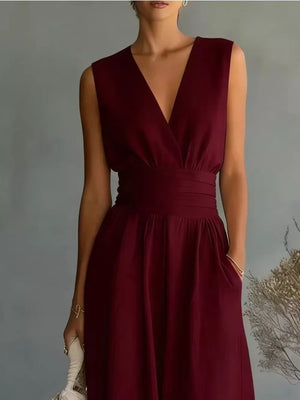 Maroon sleeveless V-neck wrap dress with a cinched waist and pockets.