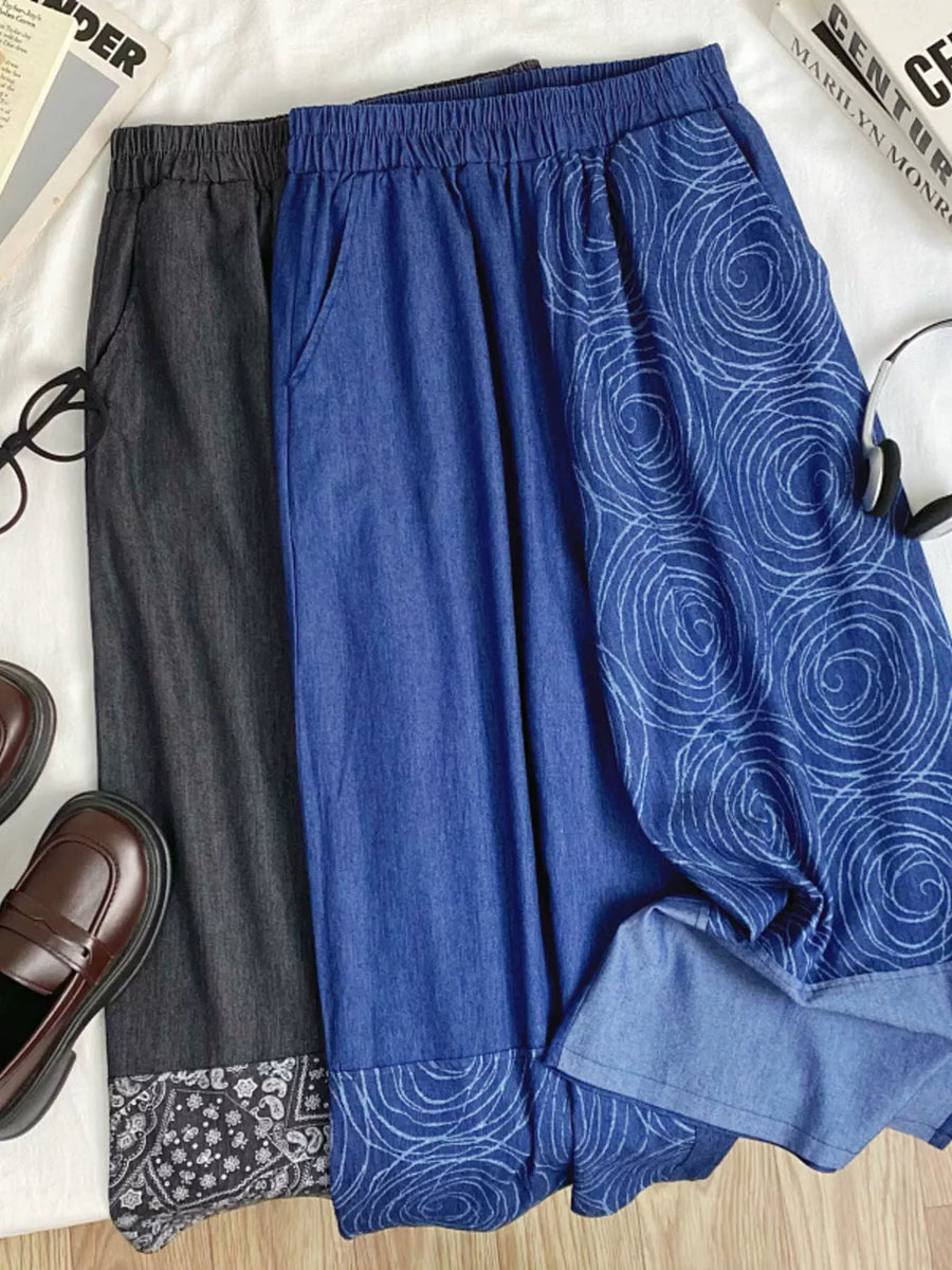 Blue cotton blend jeans with drawstring waist and rose print, black jeans with paisley print hem.