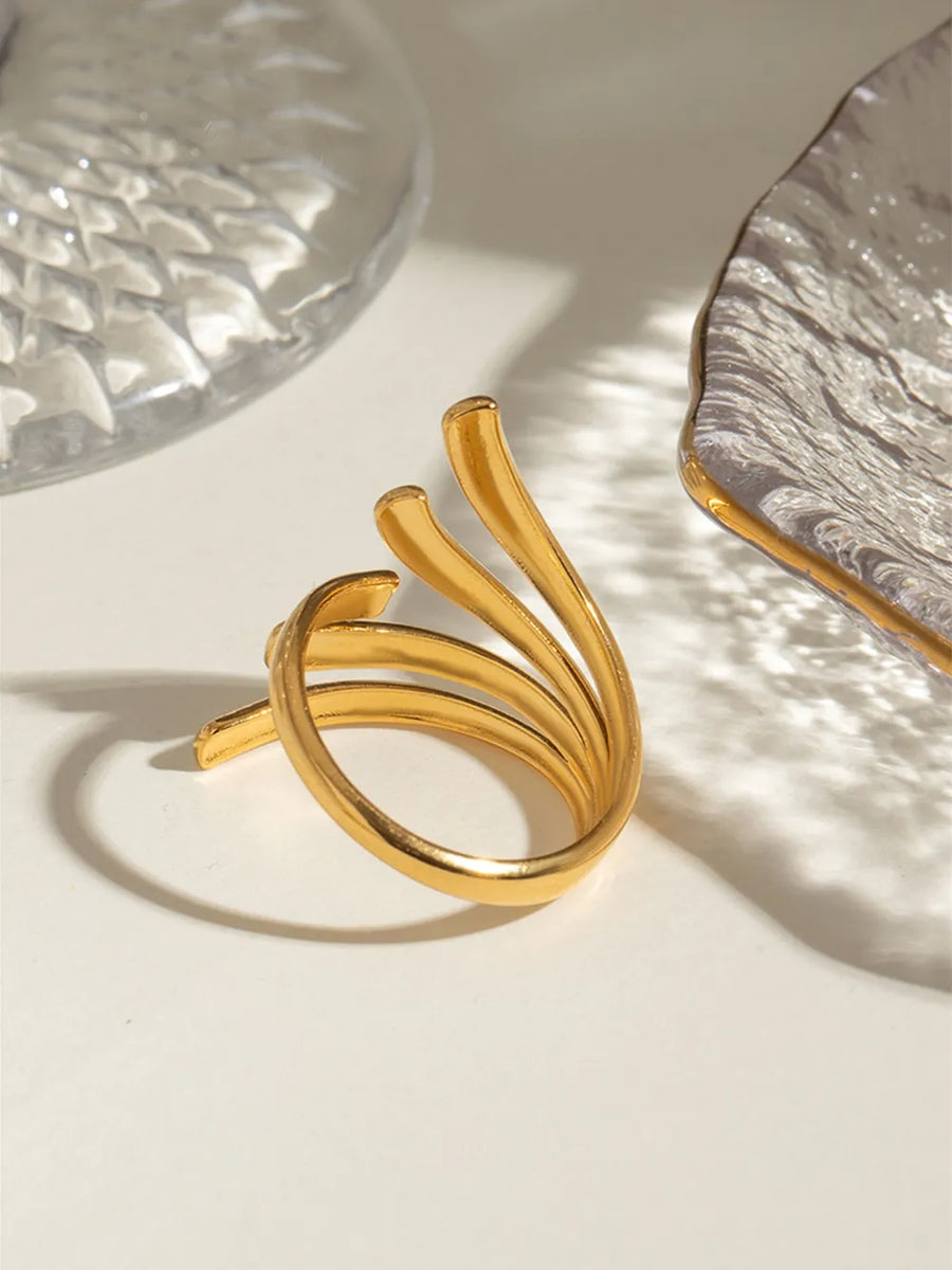 Sculptural spiral ring in gold, 18K gold-plated, with a unique layered band design.