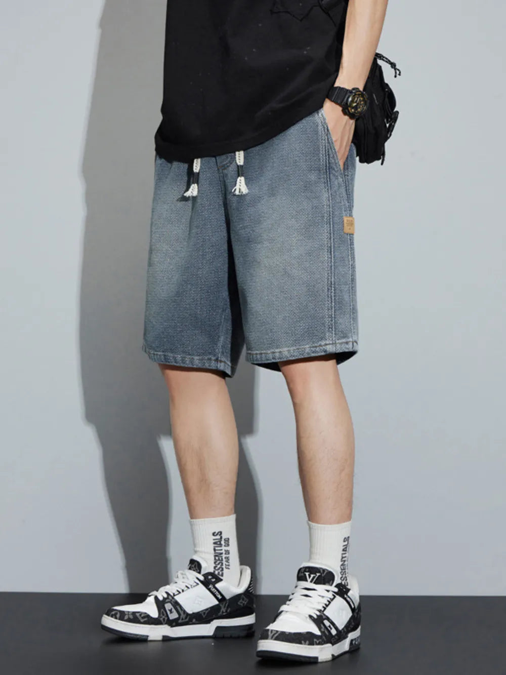Men's light blue denim shorts with drawstring and loose fit