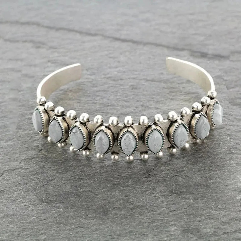 Open bangle bracelet with light gray cabochons and silver bead accents
