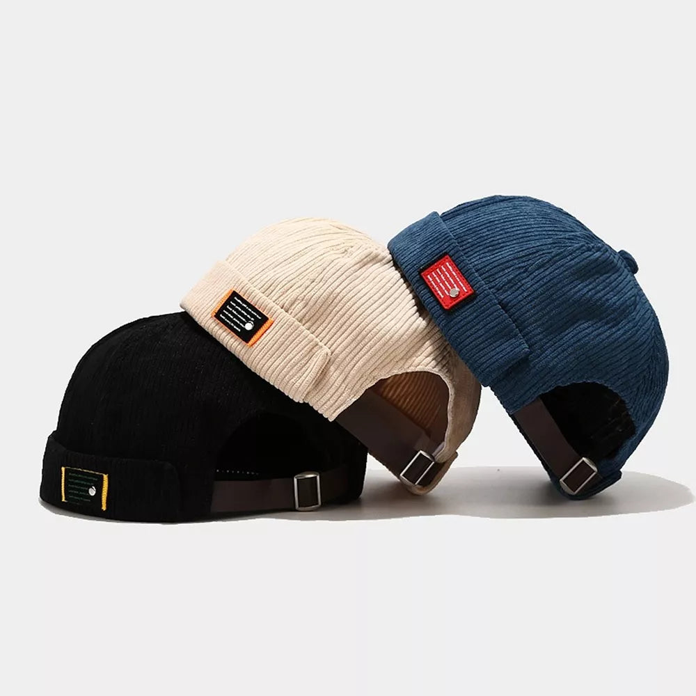 hat in black featuring brimless and fitted fit