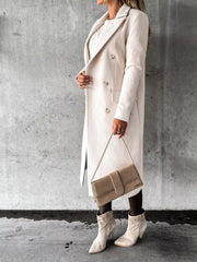 Chic double-breasted longline trench coat in apricot with buttoned front and notched lapels.