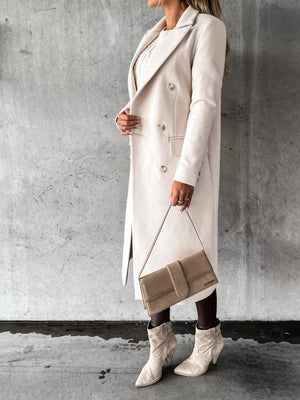 Chic double-breasted longline trench coat in apricot with buttoned front and notched lapels.