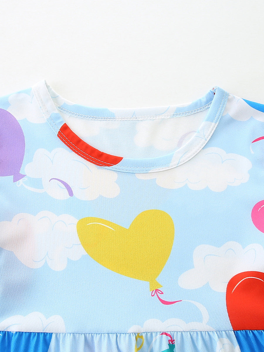 Toddler dress with heart balloon print on sky blue background, round neck, short sleeves, and ruffled hem.