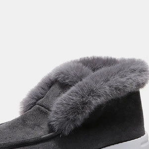 Dark gray suede slip-on booties with plush faux fur trim.