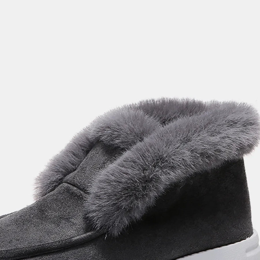 Dark gray suede slip-on booties with plush faux fur trim.