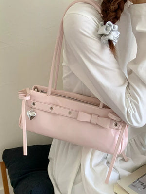 Pink PU leather shoulder bag with bow detail and heart charm