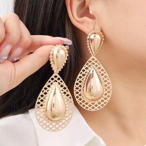 silver earrings featuring hollowed-out and geometric
