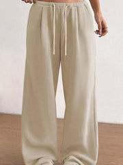 Tan wide-leg maternity joggers with drawstring waist and pockets.