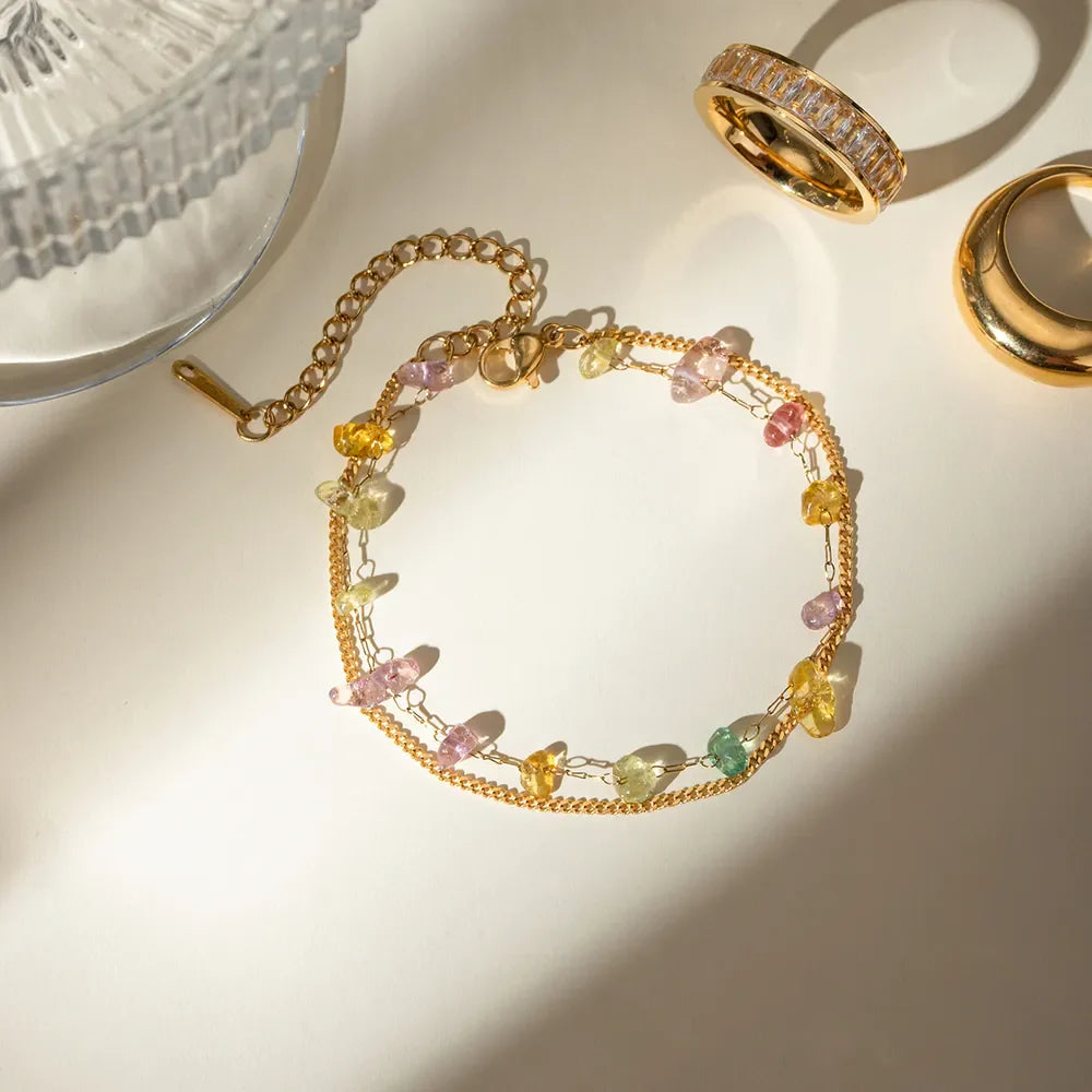 Gold double chain bracelet with colorful gemstone accents and adjustable clasp