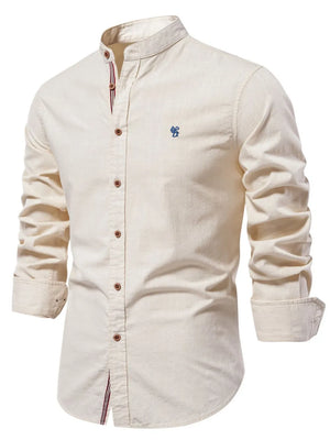 Light beige linen shirt with mandarin collar and blue embroidered detail.