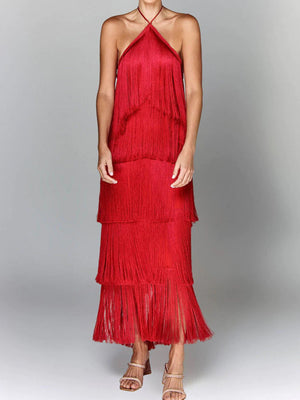Red halter neck maxi dress with tiered fringe detail and a flowing skirt.