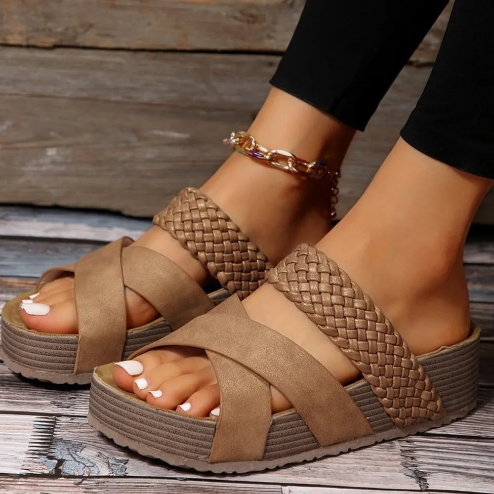 Braided strap platform slides in Camel with crisscross straps and a thick sole.