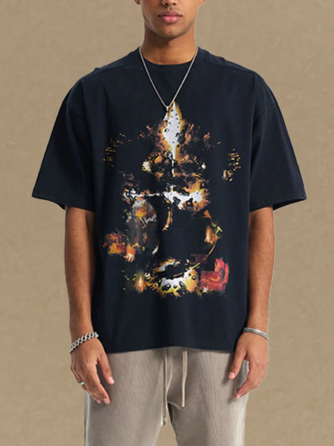 Black oversized t-shirt with abstract fiery graphic print and crew neck.