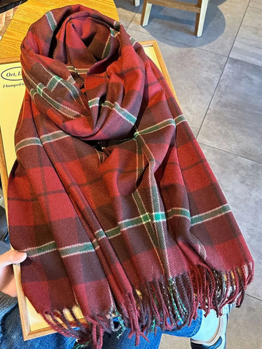 Red plaid fringe scarf with green and white accents, cozy accessory.