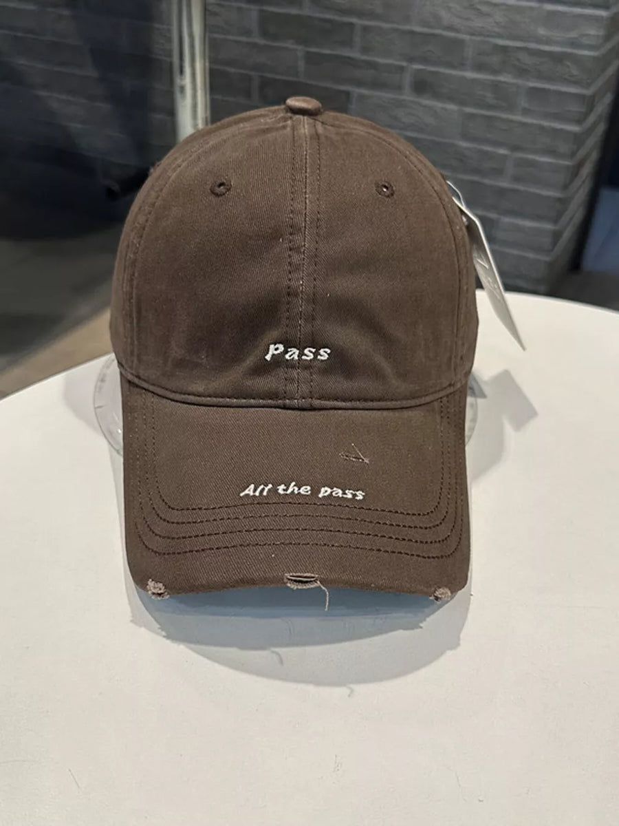 Brown cotton baseball cap with embroidered slogans and distressed details.