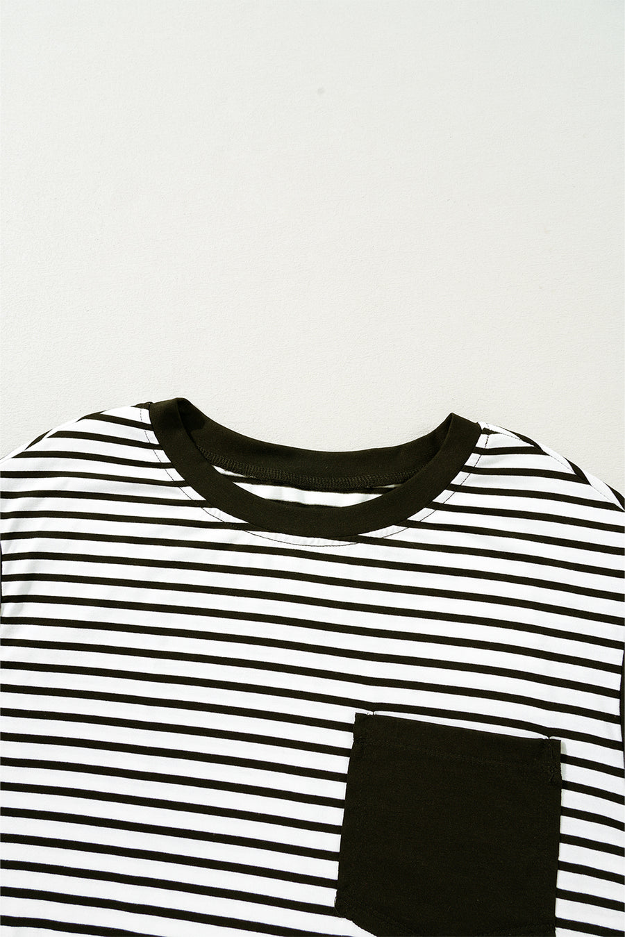 Black and white striped t-shirt with a black chest pocket and crew neck.