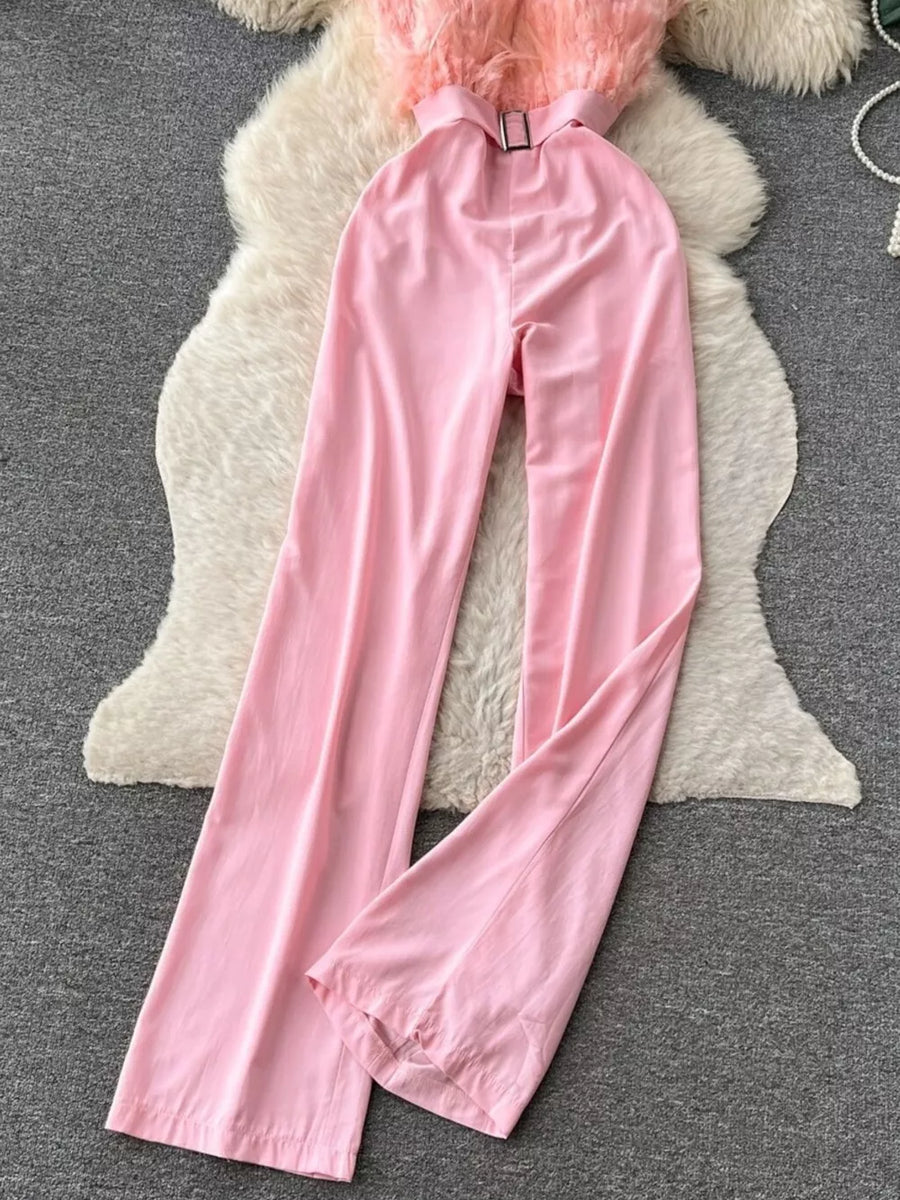 Pink strapless wide-leg jumpsuit with feather trim and belt detail.