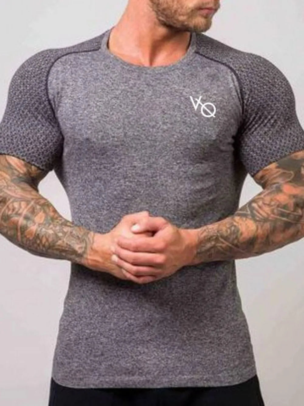 Gray performance raglan tee with white logo and textured sleeves.