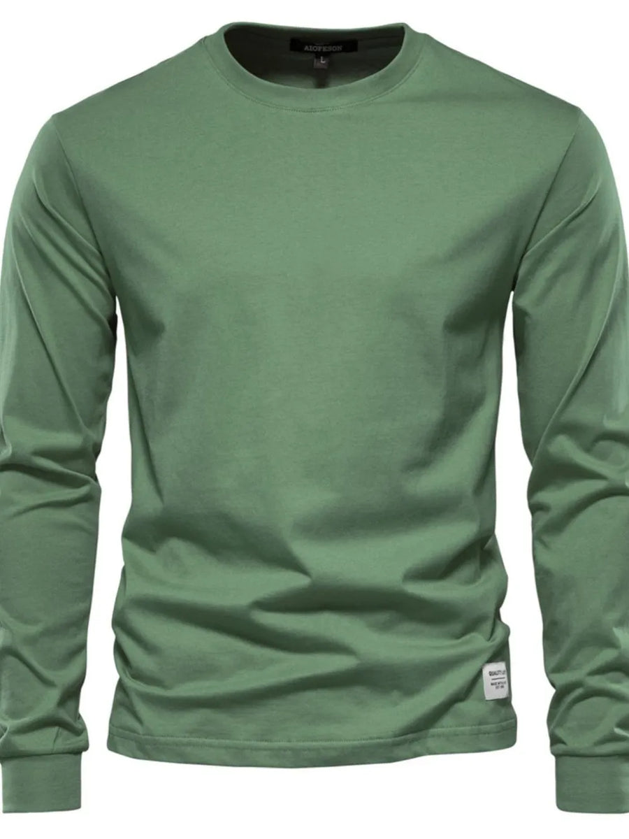 Essential crewneck long sleeve t-shirt in Matcha Green with a small woven label detail.
