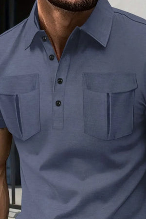 Dusty blue polo shirt with two flap chest pockets and button placket.