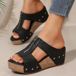 Black zip-front cork wedge sandals with stud details and open toe.