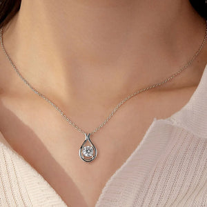 Silver teardrop moissanite pendant necklace with a sculpted sterling silver setting.