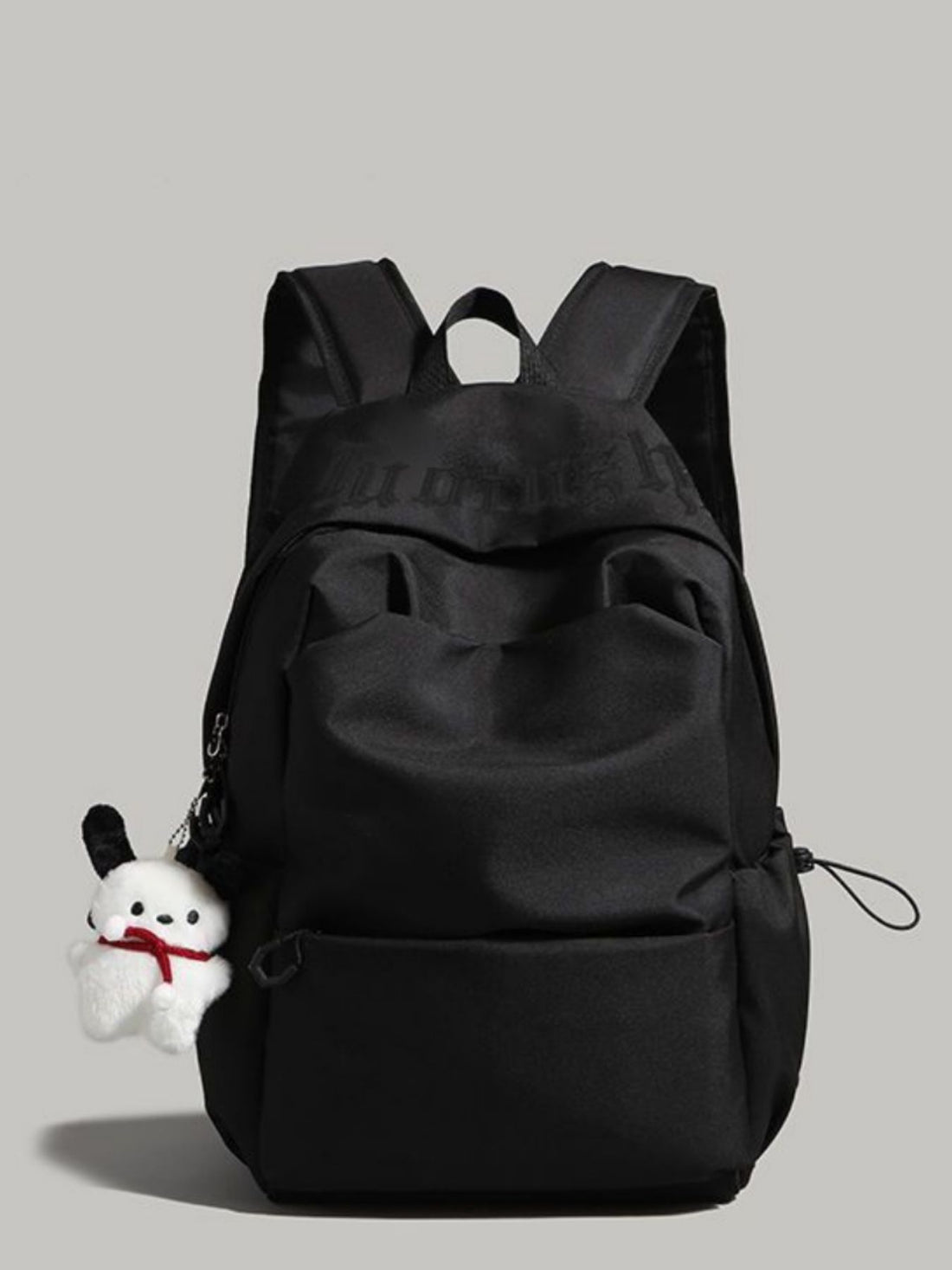 Black nylon drawstring backpack with padded straps and plush charm