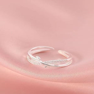 Sterling silver crossover ring with delicate pave details and open band