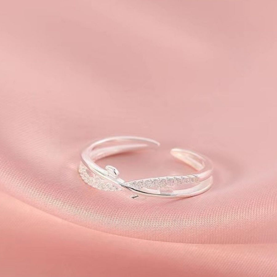 Sterling silver crossover ring with delicate pave details and open band