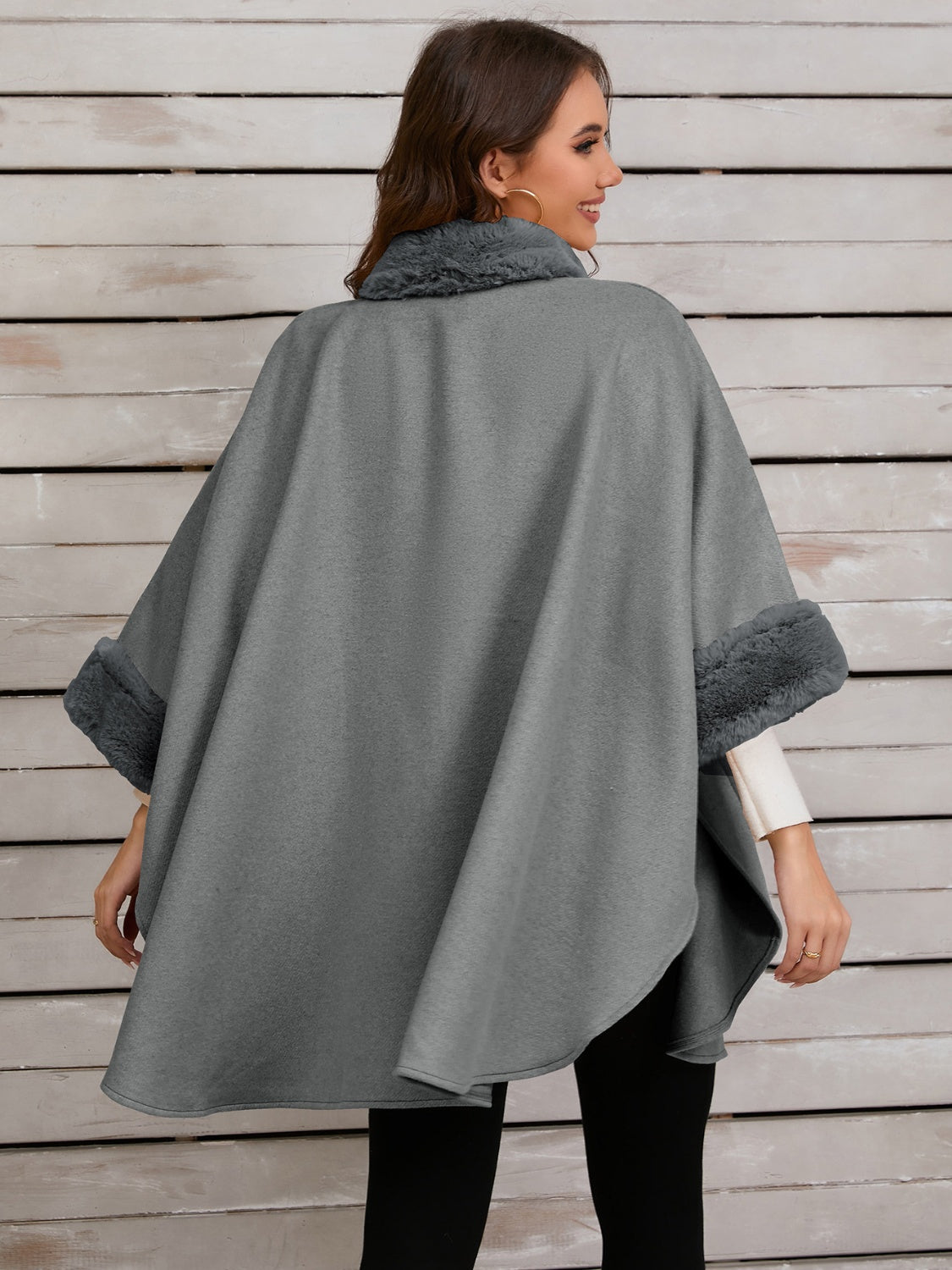 Gray faux fur trimmed cape coat with wide sleeves and a cozy collar.