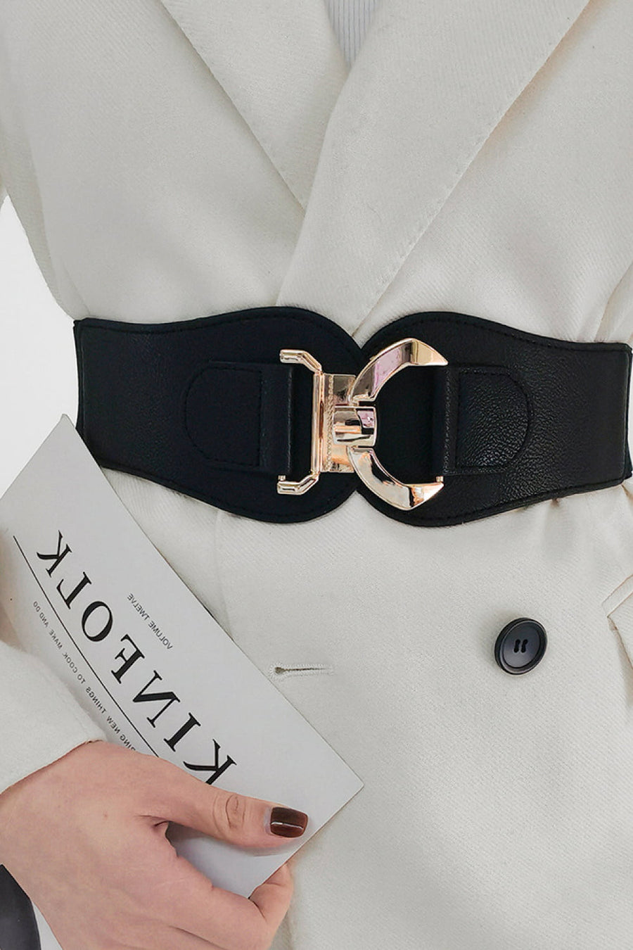 Black elasticated corset belt with sculpted gold-tone buckle detail.