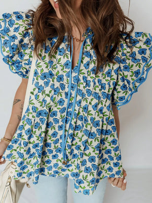 Floral ruffle sleeve tie-neck blouse with blue floral print and frill trim.