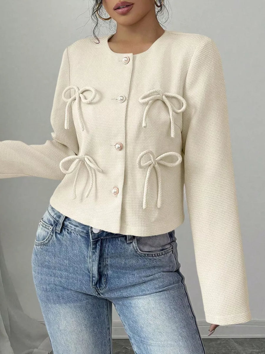 Cream textured jacket with bow details and round neck