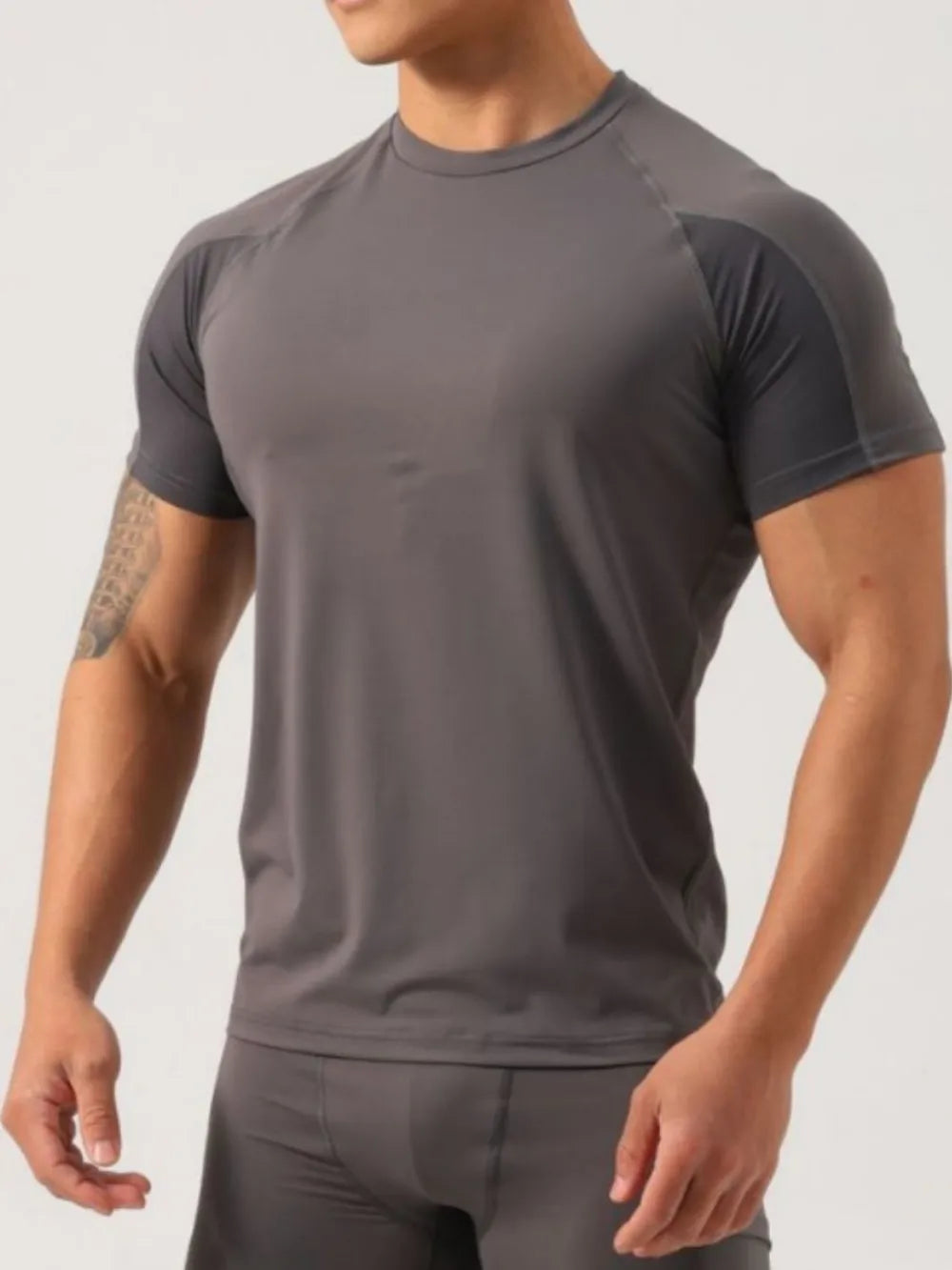 Men's gray activewear t-shirt with contrasting darker gray raglan sleeves and crew neck.