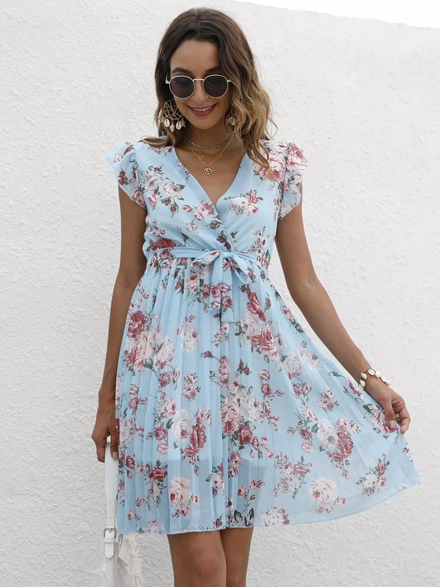 Light blue floral pleated dress with ruffle sleeves and a belted waist.