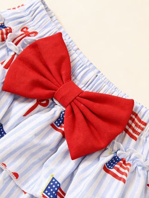 Patriotic baby outfit with red bow and American flag print on blue stripes.